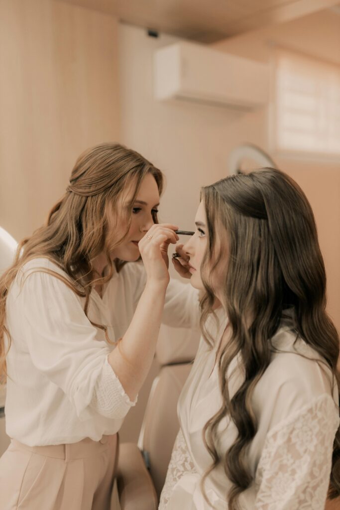 makeup artist doing makeup on christain bride